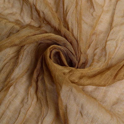 Textured golden fabric in a swirling pattern.