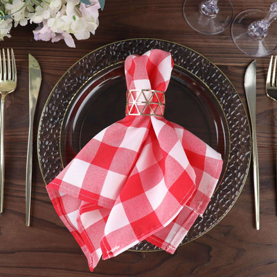Red and white checkered napkin on an elegant dinner plate setting.