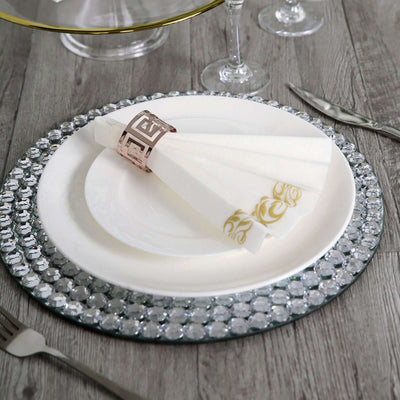 Elegant dinnerware set with decorative napkins and crystal charger plate.