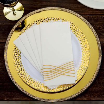 Elegant gold-accented napkins on a decorative plate.