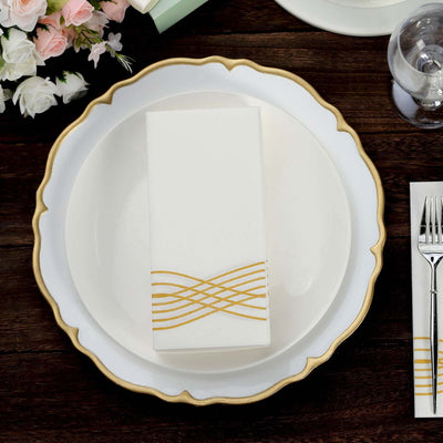 Elegant white box with gold wave design on a decorative plate setting.