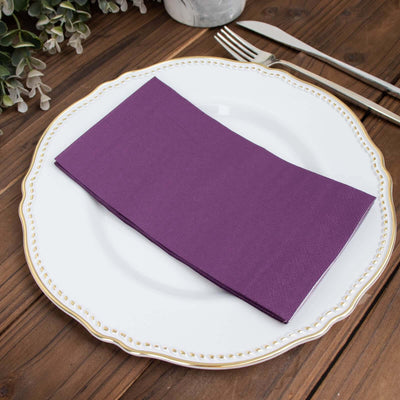 Purple napkin elegantly placed on a decorative plate.