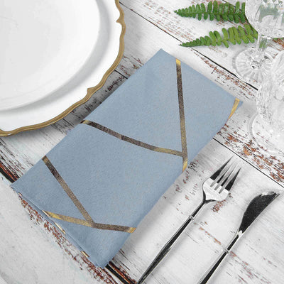 Elegant blue napkin with gold accents on a rustic table setting.