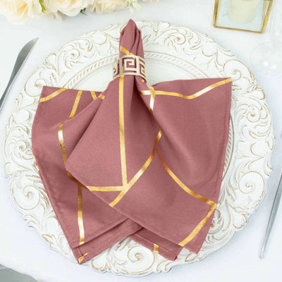 Rose gold patterned napkin elegantly arranged on a decorative plate.