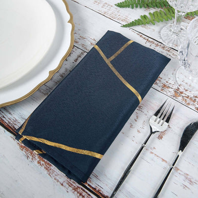 Navy napkin with gold stripes on rustic table setting