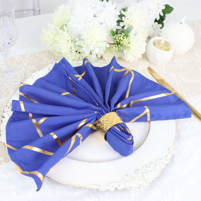 Elegant blue napkin with gold accents, beautifully arranged on a decorative plate.