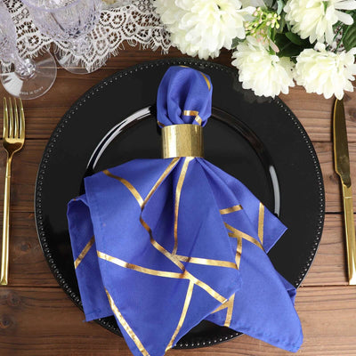 Elegant blue napkin with gold accents on a black plate. Perfect for dining decor.