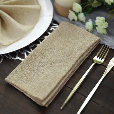 Brown linen napkin folded neatly on a rustic wooden table setting.