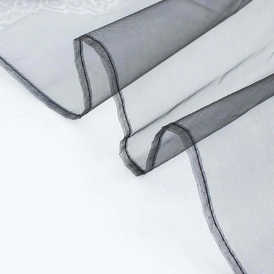 Black sheer fabric draping elegantly on a white background.
