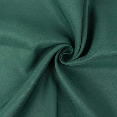 Green fabric swirl texture close-up shot.