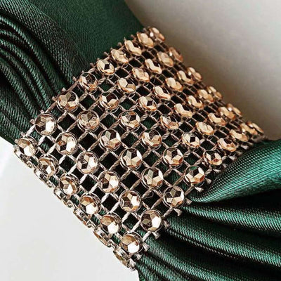 Emerald green ribbon with jeweled embellishment detail.