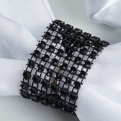 Black beaded napkin ring on white fabric