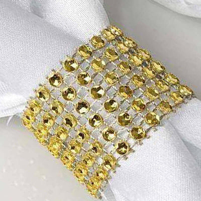 Gold rhinestone napkin ring on a white napkin