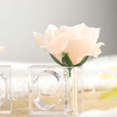Clear vase with pink flower, suitable for home decor.