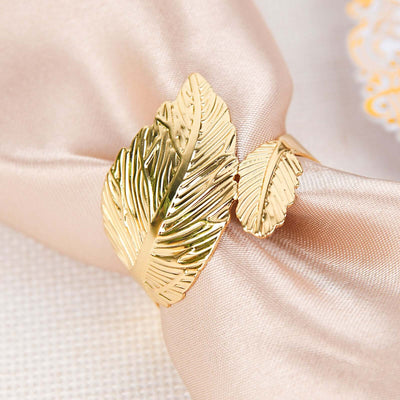 Gold leaf napkin ring on elegant fabric.