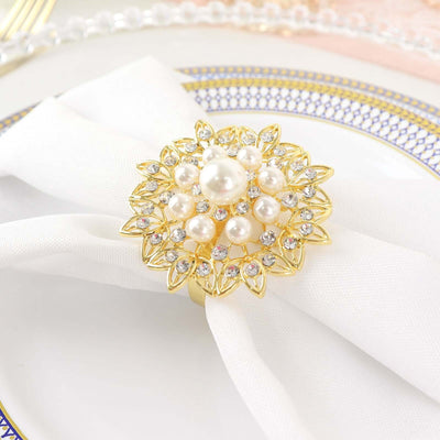 Elegant gold and pearl napkin ring on a white table setting.