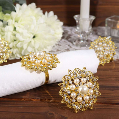 Elegant gold and pearl napkin rings on a beautifully set table.