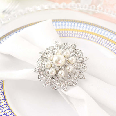 Elegant pearl and crystal napkin holder on a white napkin.