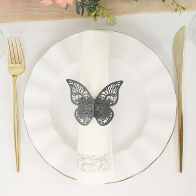 Decorative butterfly napkin holder on elegant dining plate setting.