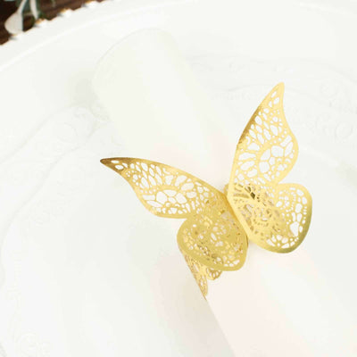 Golden butterfly napkin ring on a white plate.