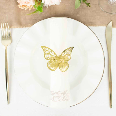 Elegant gold butterfly napkin holder on a white plate setting.