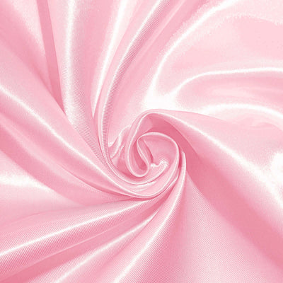Pink satin fabric with a glossy finish, perfect for sewing and crafts.