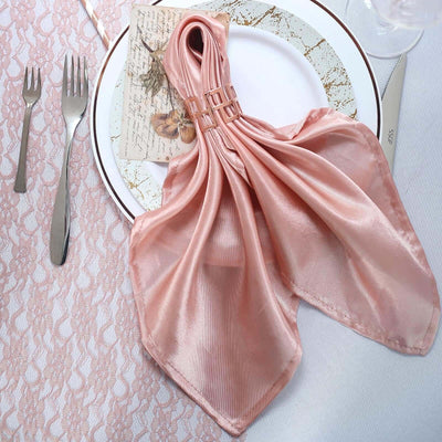 Elegant pink satin napkin elegantly displayed on a decorative plate.