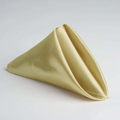 Gold satin napkin folded in a cone shape