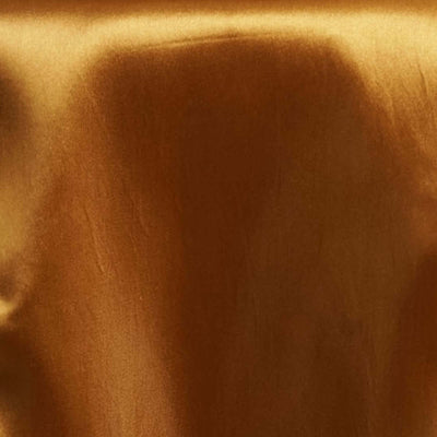 Shiny golden brown fabric texture close-up shot.