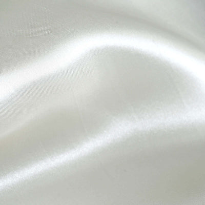 Smooth white satin fabric texture close-up.
