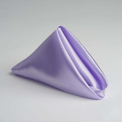 Lavender satin napkin folded in a triangular shape