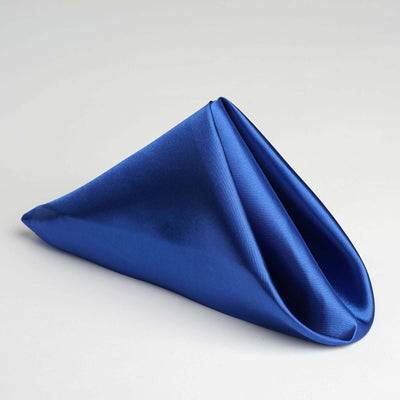 Blue satin napkin elegantly folded in a triangular shape.