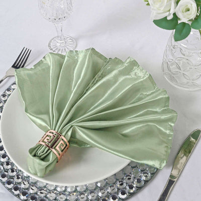 Elegant green satin napkin folded beautifully on a table setting.