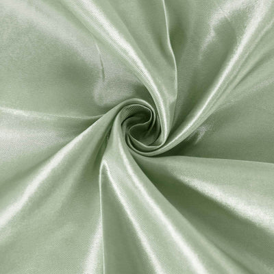 Green satin fabric texture in a spiral pattern.