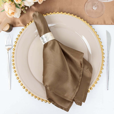 Elegant brown satin napkin on a decorative plate setting.