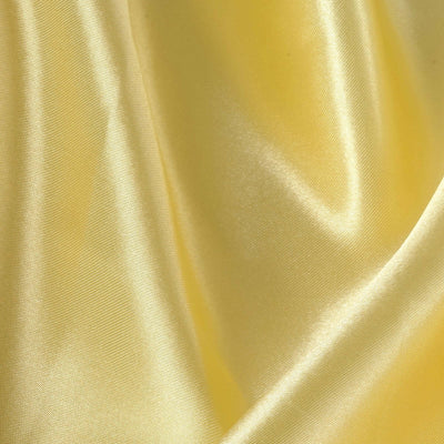 Yellow satin fabric with a smooth, shiny surface and flowing texture.