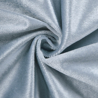 Soft blue velvet fabric swirl texture close-up.