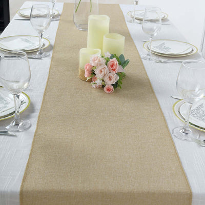 Table runner with candles and floral centerpiece on a dining table setting.