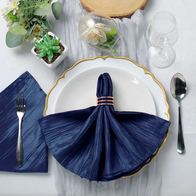 Elegant navy napkin on a beautifully set dinner table with glassware and decor.