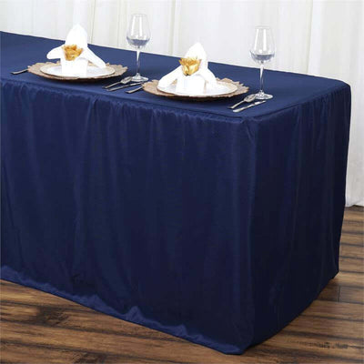 Navy blue tablecloth draped over a dining table with elegant place settings.