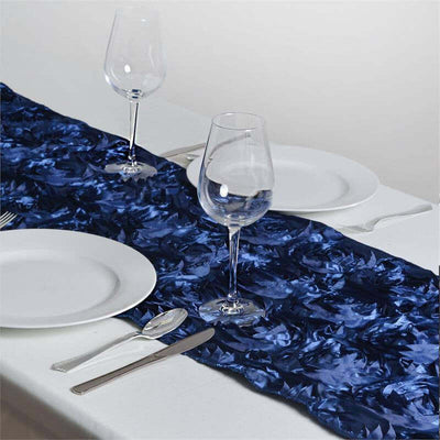 Navy blue table runner with wine glasses and plates on a white table
