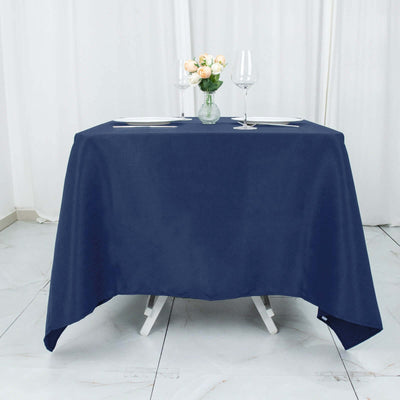 Navy blue tablecloth draped over a table with flowers and glasses