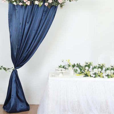 Navy blue satin drape with floral arrangement and white table decoration