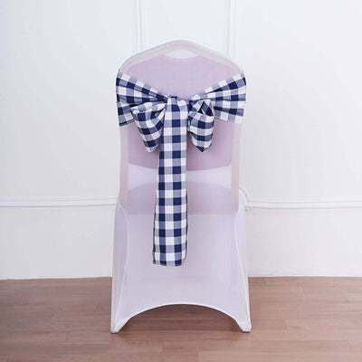 White chair with a navy and white checkered bow tied on the back