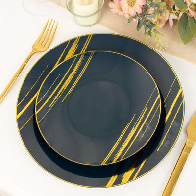 Navy blue and gold decorative plates set on a table with floral arrangement.