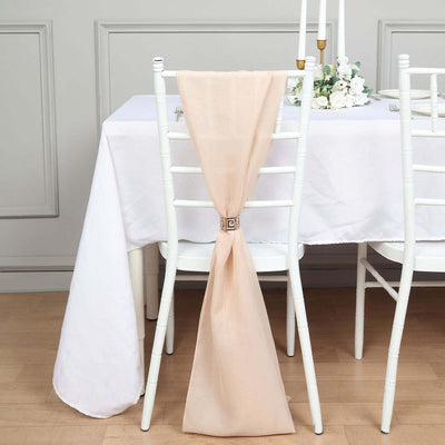 Peach chair sash tied on a white chair at an elegant table setting.