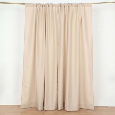 Beige curtain panel with gathered top on a plain backdrop