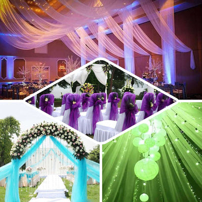 Elegant wedding decorations featuring draped fabrics, floral arrangements, and lit backdrops.