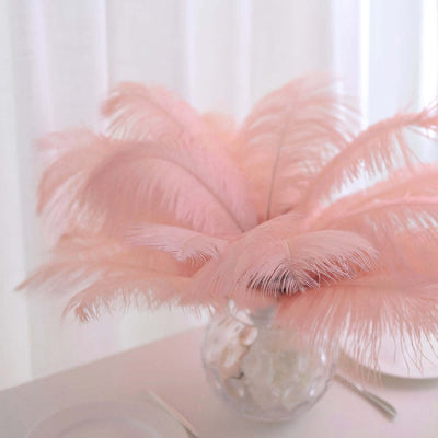 Pink feather centerpiece arrangement in a clear vase.