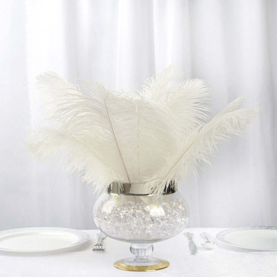 White feather arrangement in a glass vase with crystals.